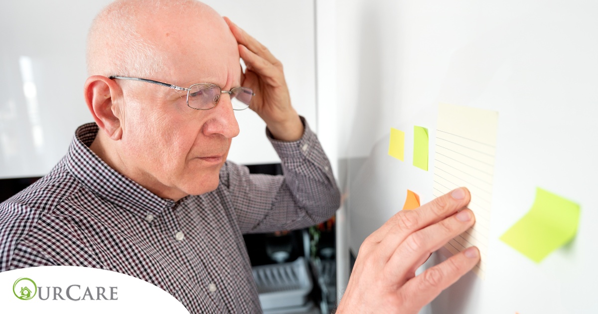 A senior looks at a board confused, representing one of the potential signs of dementia.