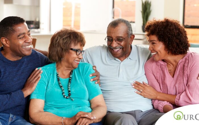 A couple sits with aging parents and enjoys their time together.