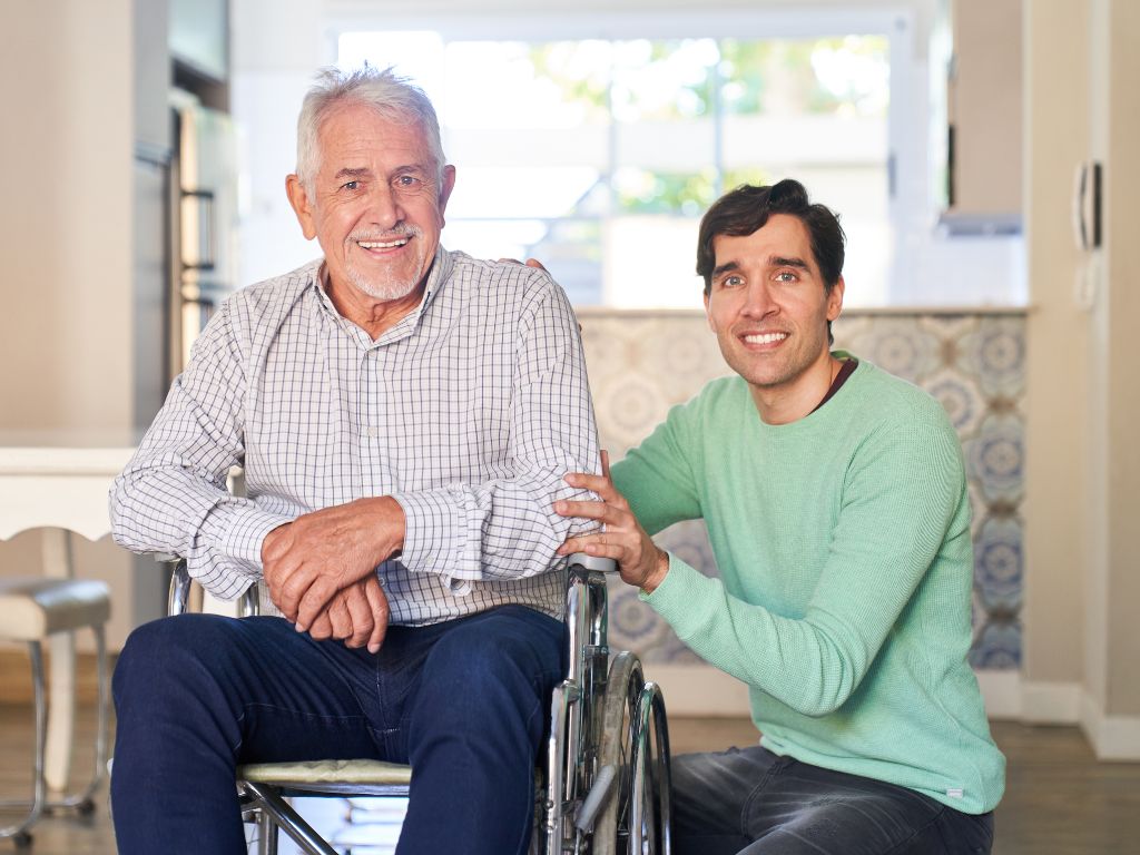 Home Caregiver Assisting Senior at Home in Harrison Caregiver providing compassionate in-home support to a senior man using a wheelchair in Harrison